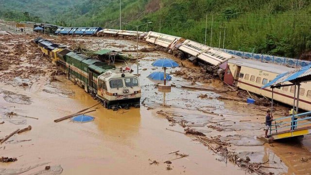 in_this_photograph_taken_on_may_16_2022_train_carriages_are_seen_toppled_over_following_a_landsli_1652796731
