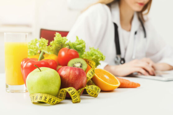Nutritionist,Desk,With,Healthy,Fruit,,Juice,And,Measuring,Tape.,Dietitian